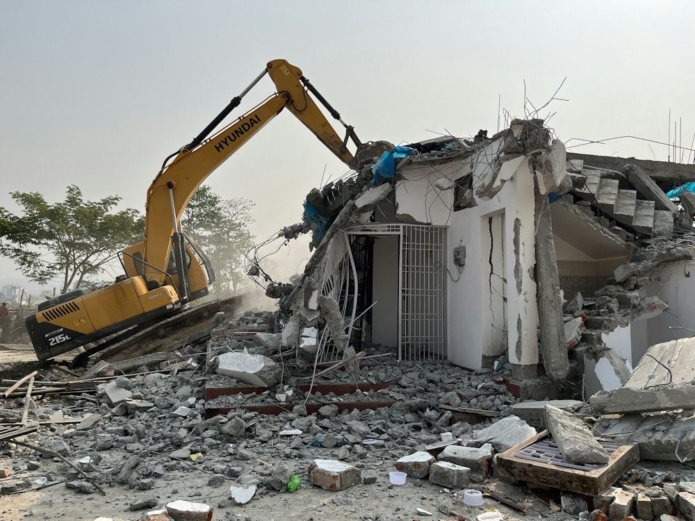 Heavy equipment clearing a demolished building