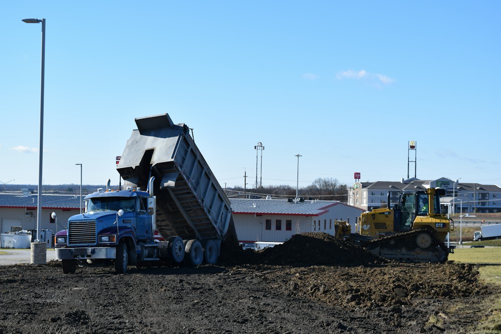 Dump truck unloading fill dirt on a job site