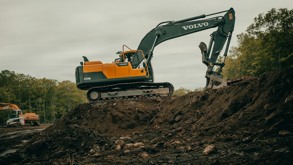 Orange excavator digging on a job site